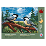 Jigsaw puzzle box featuring two black-capped chickadees on a branch with a forest background.