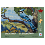Jigsaw puzzle packaging featuring a blue jay on a branch with a scenic background