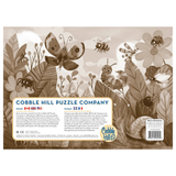 Cobble Hill Puzzle Company packaging with illustrations of insects and flowers