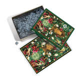 A completed jigsaw puzzle box shown with its open lid revealing loose pieces, on a clean white background. The puzzle artwork features a moose surrounded by green foliage, red flowers, and white mushrooms.