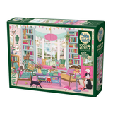 A boxed jigsaw puzzle package shown at a slight angle on a plain white background. The front of the box features a colorful illustrated scene of a cozy book-filled room with furniture, plants, and a black cat.