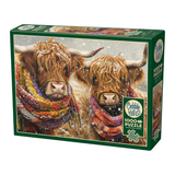 Jigsaw puzzle box featuring two highland cows wearing scarves in a snowy landscape, with 'Cobble Hill' branding.