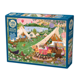 A boxed jigsaw puzzle package on a plain white background. The front shows a colorful illustrated campsite scene with tents, a lake, trees, flowers, and outdoor furniture.
