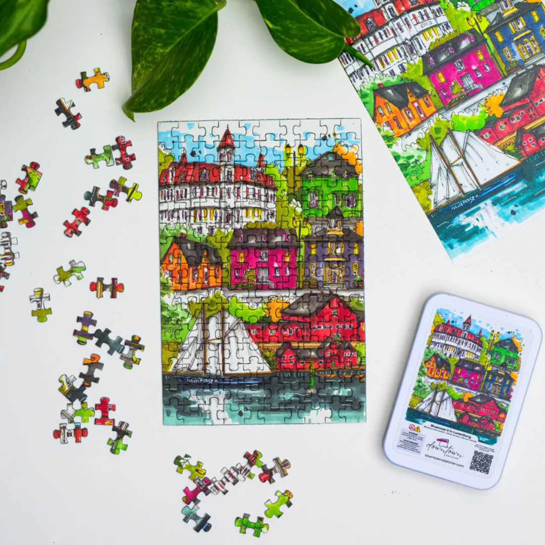 Colorful puzzle with completed pieces and packaging on a white surface