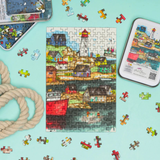 Colorful puzzle with a lighthouse design on a blue background, surrounded by additional puzzle pieces.