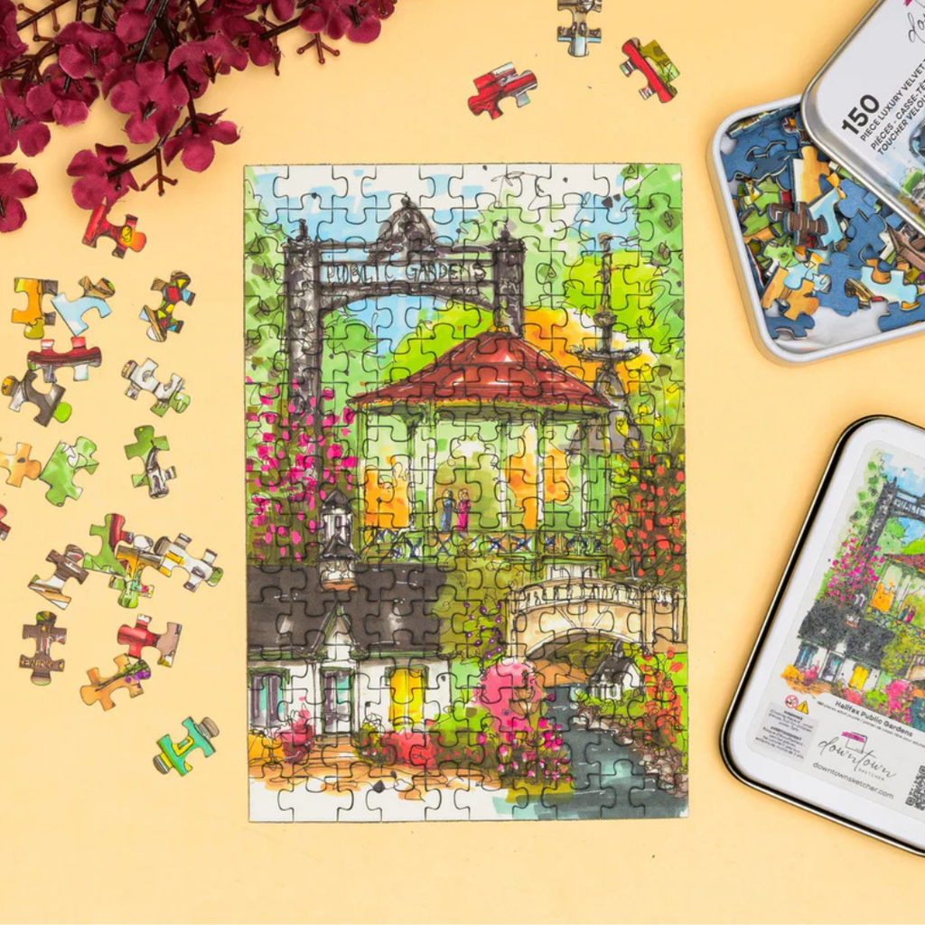 Colorful puzzle with a partially completed scene on a yellow background, surrounded by puzzle pieces and packaging.