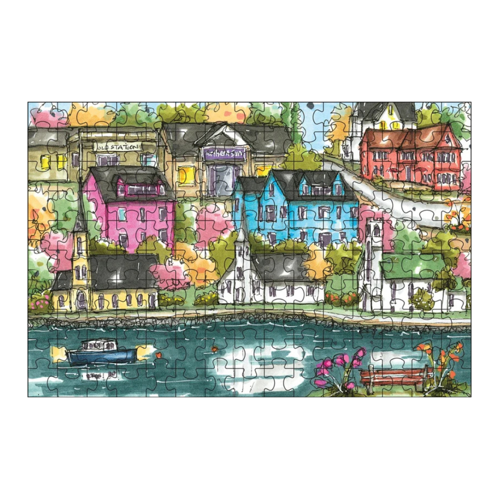 Colorful puzzle of a town scene with houses and a river.