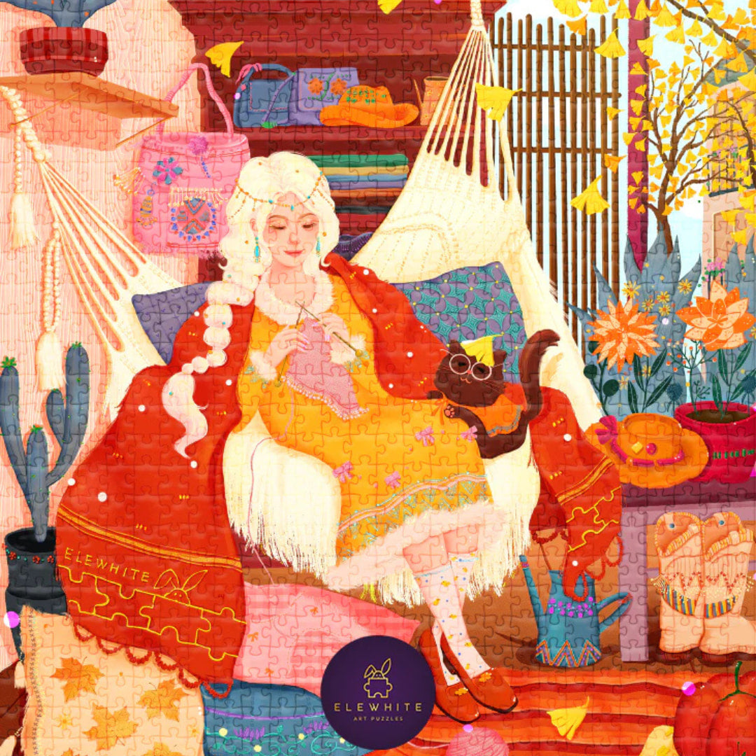 Colorful jigsaw puzzle of a woman knitting with a cat, surrounded by autumn elements and a 'Elewhite' logo.