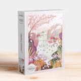 Puzzle box with a colorful design of a garden scene on a wooden surface.