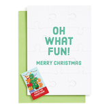 Christmas puzzle with a card featuring 'Oh What Fun! Merry Christmas' text on a white background.