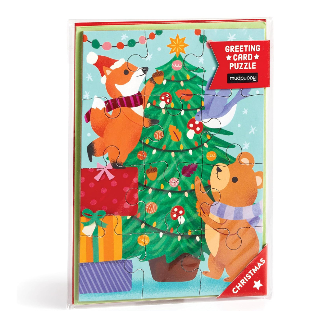 Greeting card puzzle with Christmas design featuring animals around a tree, Mudpuppy brand visible.