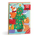 Greeting card puzzle with Christmas design featuring animals around a tree, Mudpuppy brand visible.