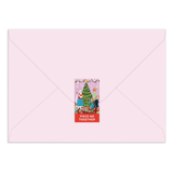 Pink envelope with a Christmas-themed card featuring a tree and people.