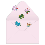 Pink envelope with colorful puzzle piece stickers on a white background