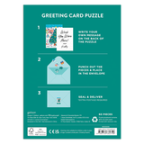 Greeting card puzzle packaging with instructions on a teal background