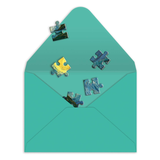 Colorful puzzle pieces on a teal envelope against a white background