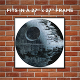 Framed artwork of the death star on a brick wall with text indicating size of frame needed to mount the puzzle