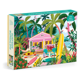 Jigsaw puzzle box with a colorful design of a beach house and palm trees.