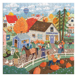 A completed autumn-themed jigsaw puzzle featuring a colorful village scene with houses, people, pumpkins, trees, and a horse, shown against a plain white background.