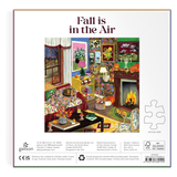 Front of a Galison jigsaw puzzle box titled 'Fall is in the Air', showing a colorful illustrated cozy living room scene with autumn decor, a fireplace, and puzzle piece icon on a white background.