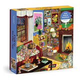 A boxed jigsaw puzzle package shown at a slight angle on a plain white background. The front of the box features a colorful illustrated living room scene with autumn decor, a fireplace, flowers, and furniture.
