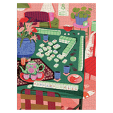 A colorful jigsaw puzzle depicting a cozy living room scene centered around a green mahjong table, with matching tiles, a pink sofa, potted plants, and a teapot on a table in the foreground.
