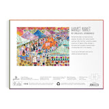 The back of a jigsaw puzzle box describing Michael Storrings Harvest Market  featuring a classic farmer's market bustling about on an Autumn's day. 