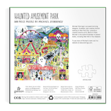 Back of a 500-piece jigsaw puzzle package titled 'Haunted Amusement Park' by Michael Storring. The package features a colorful illustrated scene of a haunted fairground with rides, tents, ghosts, and signage, plus product details, a small 'actual size' puzzle outline, and a barcode.