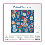 Puzzle packaging for 'Potted Teacups' with colorful teacup and floral design on a blue background.