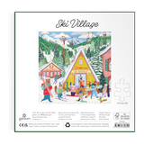 Square product packaging for a jigsaw puzzle titled 'Ski Village,' showing a colorful illustrated winter mountain scene with cabins, skiers, and snow. The package includes product details, a small outline of the puzzle pieces, and a barcode on a white background with a thin green border.
