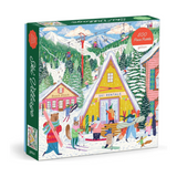 A 500-piece jigsaw puzzle box by Galison, featuring a colorful winter mountain village scene with ski lifts, snowy hills, cabins, and people engaging in winter activities. The box is shown at a three-quarter angle against a plain white background.