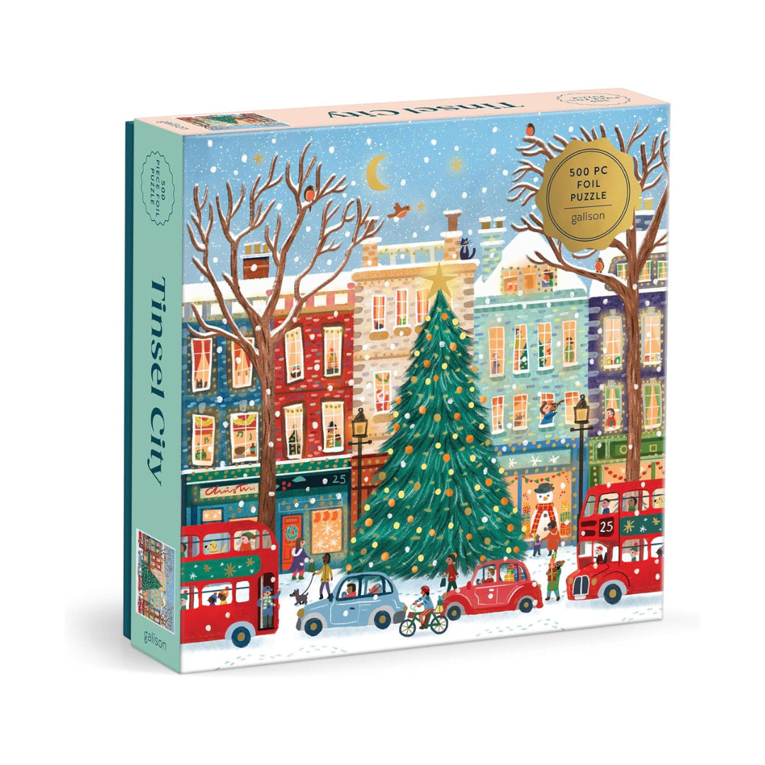 Puzzle packagaing featuring a holiday town and christmas tree 