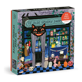 A 500-piece jigsaw puzzle box titled 'Ye Olde Spooktacular Shop' by Galison, featuring a colorful, whimsical illustration of a haunted shop with a black cat, skeletons, pumpkins, and a checkered floor.