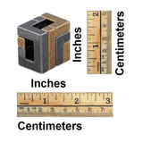 Cube with measurement scales for inches, centimeters, and millimeters on a white background