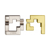 Two geometrically shaped metal puzzle pieces, one silver and one gold, on a white background.