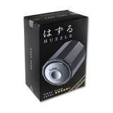 Black packaging of Huzzle with a silver product inside on a white background