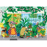 A colorful illustrated scene of a greenhouse or flower shop filled with potted plants, flowers, shelves, and two people browsing among the greenery. The artwork is highly detailed with many shades of green, pink, yellow, blue, and orange.