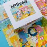 Holiyay puzzle box with a colorful illustration on top of a partially completed puzzle.