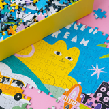 Partial puzzle with colorful pieces including a cat and school bus design.