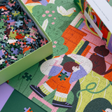 Colorful puzzle with a child on a bike and a dog, partially completed, in a box.