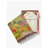 A puzzle box featuring a colorful illustrated box lid with a red train and autumn trees, next to a cream drawstring pouch printed with the text 'Choose pieces over pixels.' and a small red pixel-art logo, all inside an open red box on a light gray background.