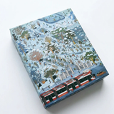A square decorative puzzle box featuring a detailed winter illustration with snow-covered trees, small figures, and a red and white streetcar along the bottom, photographed on a clean white background.