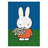 Jigsaw puzzle with a cartoon rabbit character holding flowers on a blue and green background