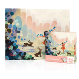 Jigsaw puzzle packaging with artistic design of a woman and rabbits in a forest setting.