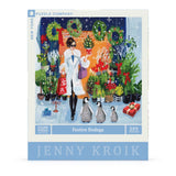 Jigsaw puzzle box featuring a festive scene with a woman, penguins, and plants, designed by Jenny Kroik.