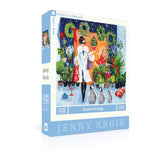 Jenny Kroik puzzle box with a woman and penguins design on a white background