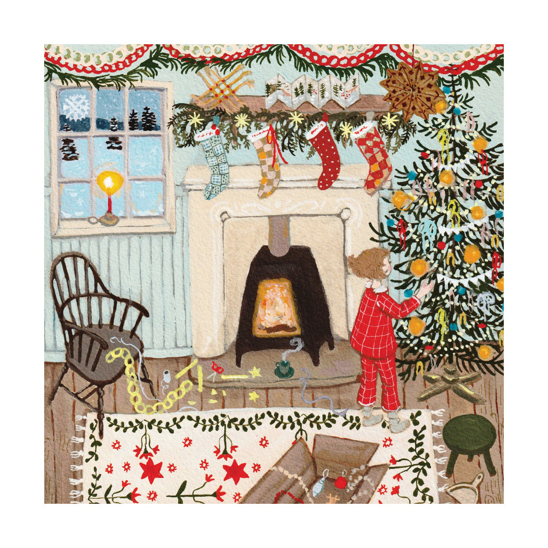 Illustration of a child decorating a Christmas tree in a cozy living room with a fireplace.