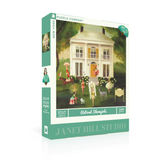 Jigsaw puzzle box featuring a vintage scene with people and animals in front of a house, branded by Janet Hill Studio.