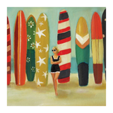 Woman holding a surfboard among colorful surfboards on a beach