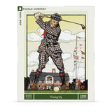 Jigsaw puzzle packaging featuring a golfer in a checkered outfit with a club, set against a scenic background.